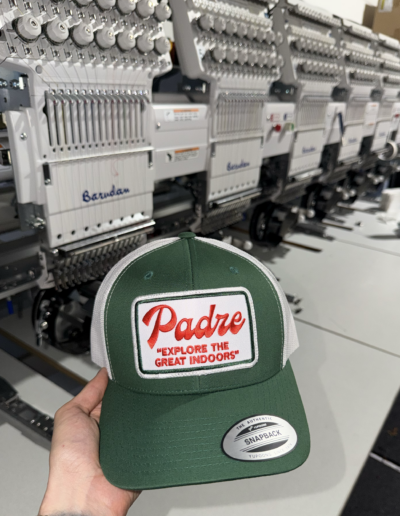 Custom Patch on a Cap with an Embroidery Machine as a background