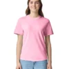 Woman wearing a pink short-sleeve T-shirt and light blue jeans, smiling at the camera against a white background.