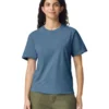 Woman wearing a blue crew-neck T-shirt and olive-green pants, standing and facing the camera with a neutral smile.