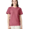 Woman in a plain rose-colored short-sleeve T-shirt, smiling at the camera against a white background.
