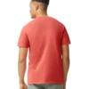 Back view of a man wearing a coral red short-sleeve T-shirt and olive-green jeans against a white background.