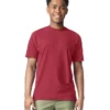 Young man with short curly hair smiling, wearing a red T-shirt and olive cargo shorts against a white background.