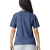 Person viewed from the back, wearing a blue short-sleeve T-shirt and light gray shorts, with dark curly hair around the shoulders