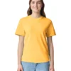 Smiling woman wearing a bright yellow T‑shirt and light blue jeans, standing against a white background.