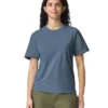 Woman wearing a blue short-sleeve crew-neck T-shirt and olive green pants, facing forward with a neutral smile.