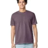Young man wearing a purple short-sleeve tee and light jeans, smiling at camera.