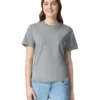 Woman wearing a plain gray crew-neck T-shirt and light blue jeans, smiling at the camera.
