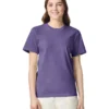 Woman in a purple short-sleeve T-shirt, standing against a white background, smiling at the camera.