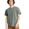 Young man wearing a gray short-sleeve T-shirt and tan pants, standing against a white background with a relaxed posture.
