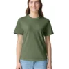 Smiling woman wearing an olive green plain t-shirt and light blue jeans, standing against a white background.