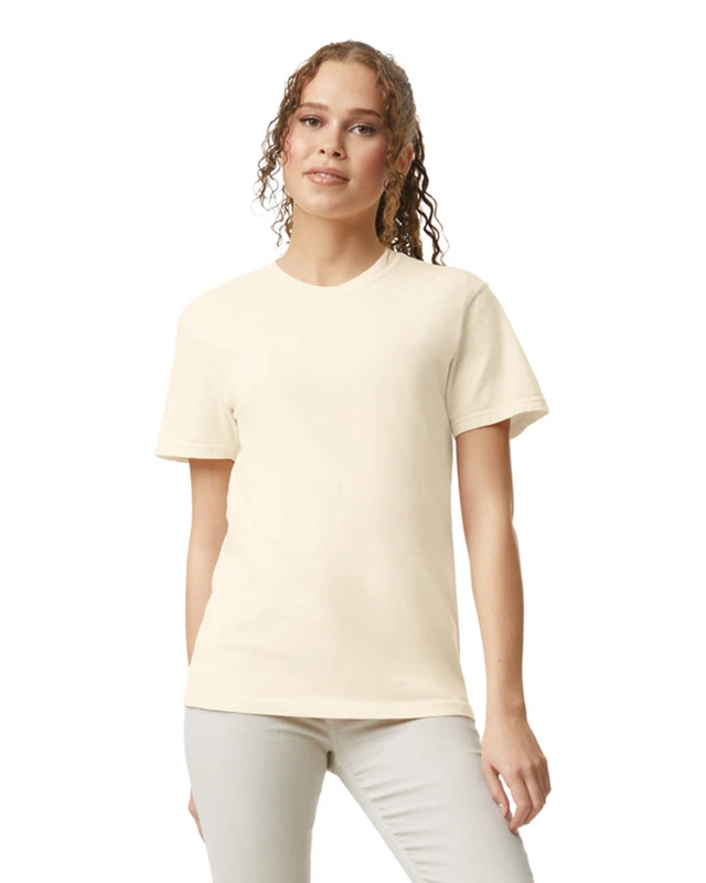 Woman wearing a cream short-sleeve T-shirt and light gray pants, standing and facing the camera.