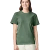 Woman wearing a green crew-neck T-shirt, standing and smiling against a white background.