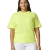 Woman with long dark hair wearing a lime green oversized T-shirt and white pants, facing the camera.