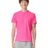 Young man with curly brown hair smiling, wearing a hot pink T-shirt and light gray cargo shorts against a white background.