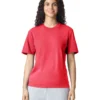 Woman wearing a red short-sleeve t-shirt and light gray sweatpants, smiling at the camera against a white background.