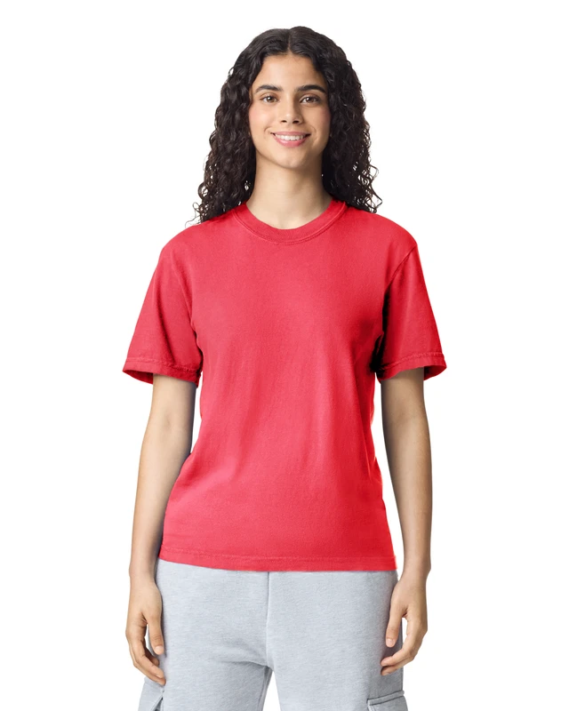 Woman wearing a red short-sleeve t-shirt and light gray sweatpants, smiling at the camera against a white background.