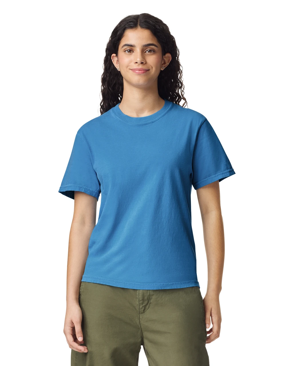 Woman wearing a blue crew-neck T-shirt and olive green shorts, facing forward with a slight smile.