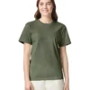 Woman wearing an olive-green crew-neck T-shirt and light beige pants, smiling at the camera on a white background.