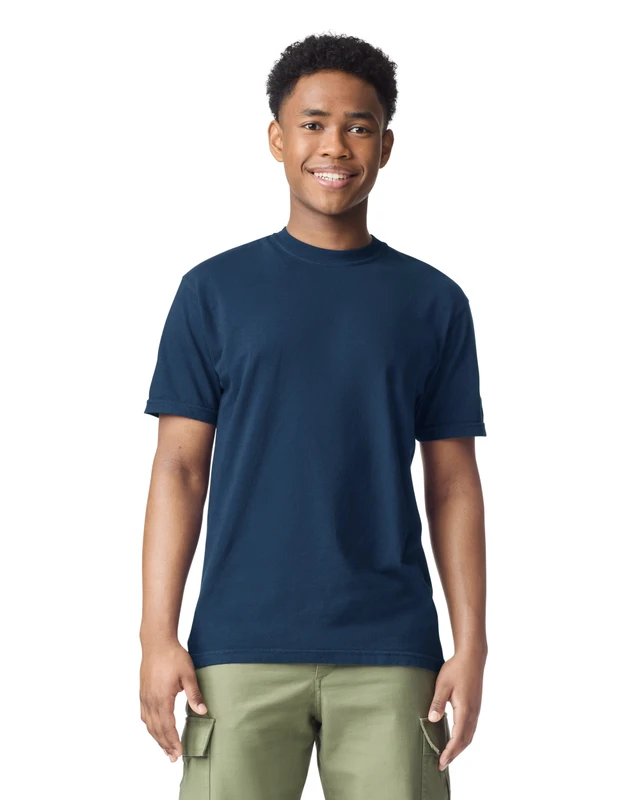 Young man smiling, wearing a navy T-shirt and olive cargo shorts against a white background.
