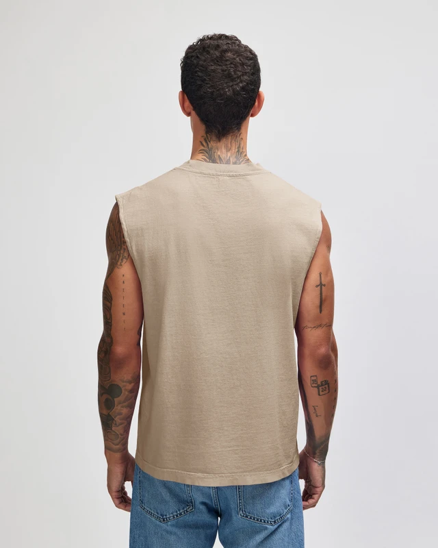 207GD_FadedBone_03__65348 Man seen from behind wearing a beige sleeveless shirt and blue jeans; tattoos on arms and neck visible.